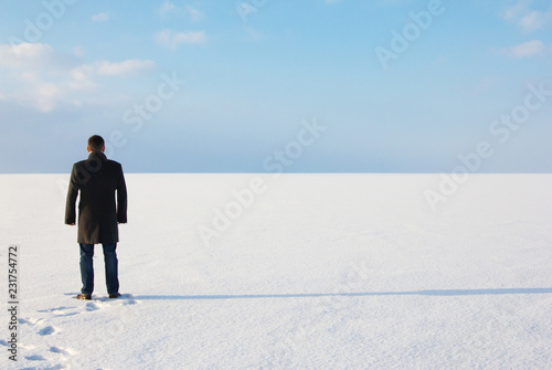 downshifting way deadpan man standing shore frozen sea relaxes winter seascape