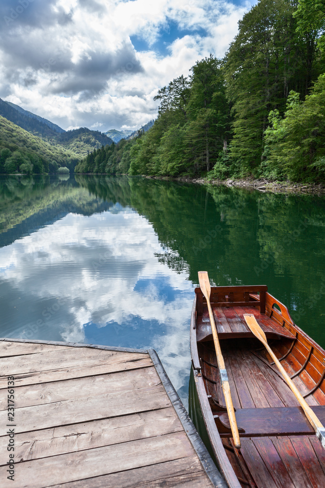 Wooden rowboat for water trip on shore of Biograd lake. The Biogradska Gora national park. Montenegro, Europa
