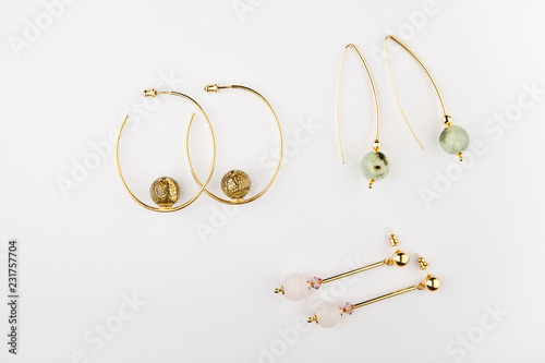 gold earrings stone set white background 