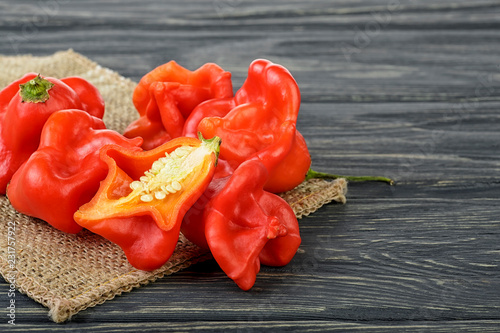 Ripe Chili Peppers on wooden background. Capsicum baccatum. photo