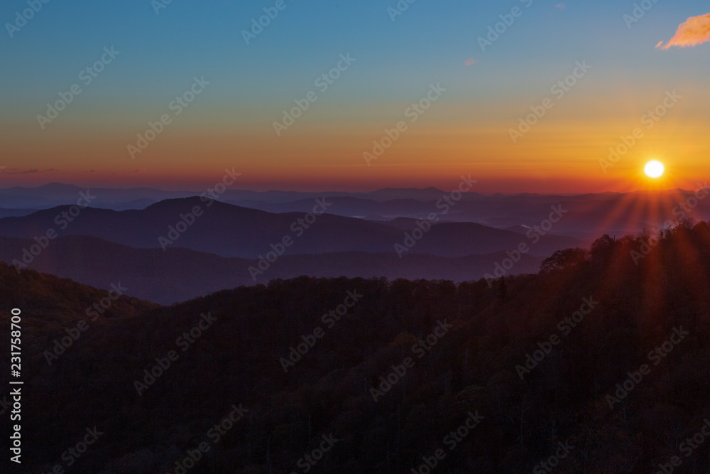 Sunrise on the Blue Ridge Parkway in Autumn with blue sky and hint of a cloud.