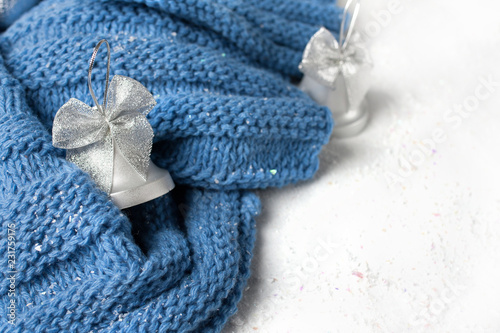 wool knitted scarf handmade deep blue colow with silver christmas toys on the snow table white