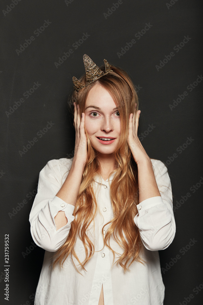 Close up portrait of adorable girl with golden crown holding han Close up portrait of adorable girl with golden crown holding han