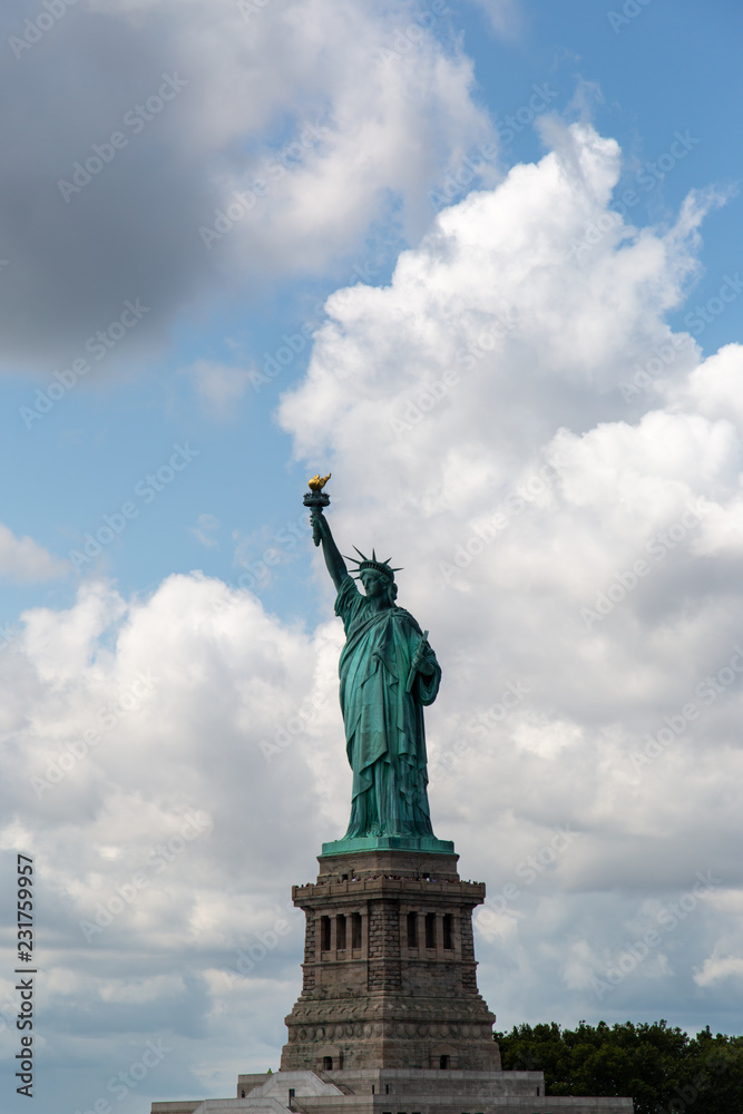 Obraz premium New York City / USA - AUG 22 2018: The statue of liberty in clear blue sky view from river