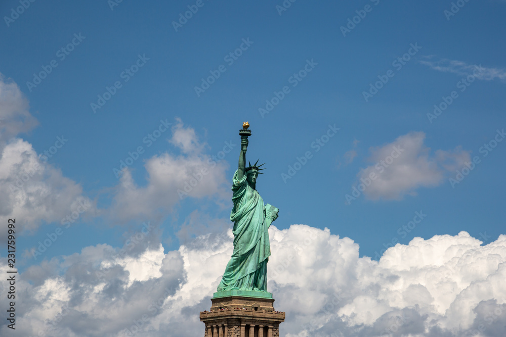 Fototapeta premium New York City / USA - AUG 22 2018: The statue of liberty in clear blue sky view from river