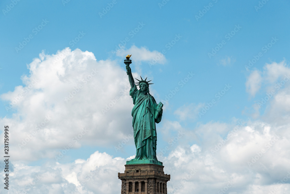 Obraz premium New York City / USA - AUG 22 2018: The statue of liberty in clear blue sky view from river