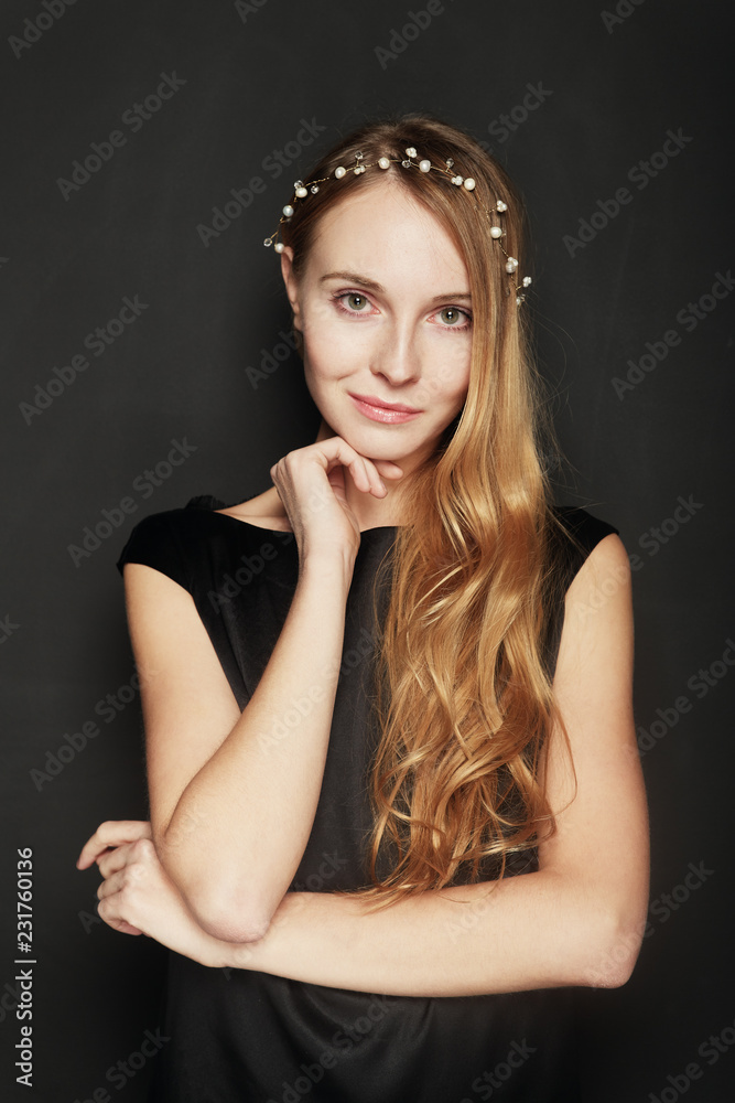 Fototapeta premium Beautiful young woman portrait on black background
