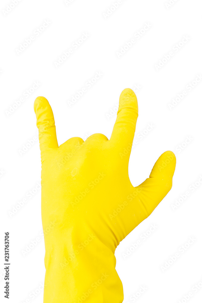 Obraz premium Hand in yellow rubber glove on white background showing gesture sign of the horns, metal horns, devil horns, rock horn. Isolated glove for cleaning on white background. The outside of the palm.