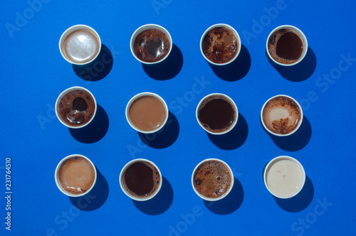Variety of coffee cups on blue background