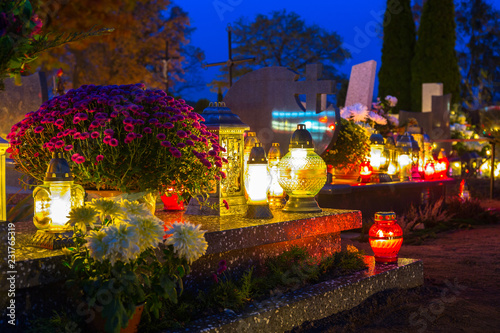 Colorful candles on the cemetery at All Saints Day, Poland © Patryk Kosmider
