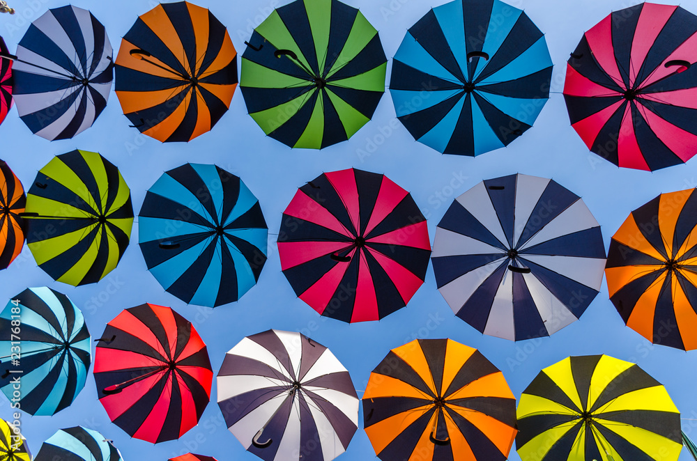 Colorful umbrellas background. Colorful umbrellas in the sunny sky. Street decoration.