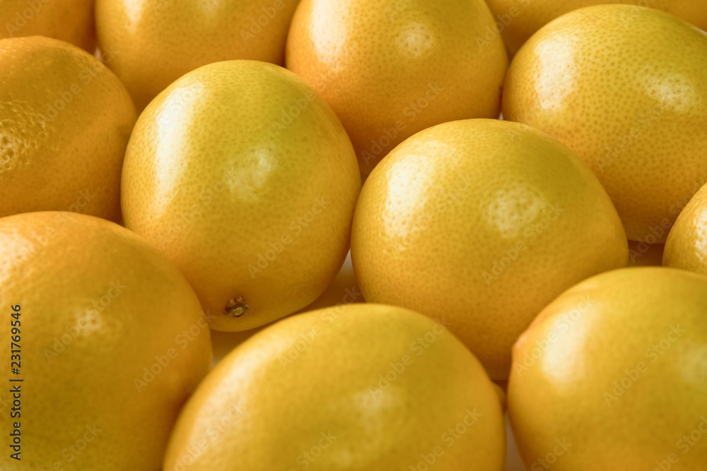 Ripe yellow lemons on white background, texture, close-up. Ripe yellow lemons on white background, texture, close-up.