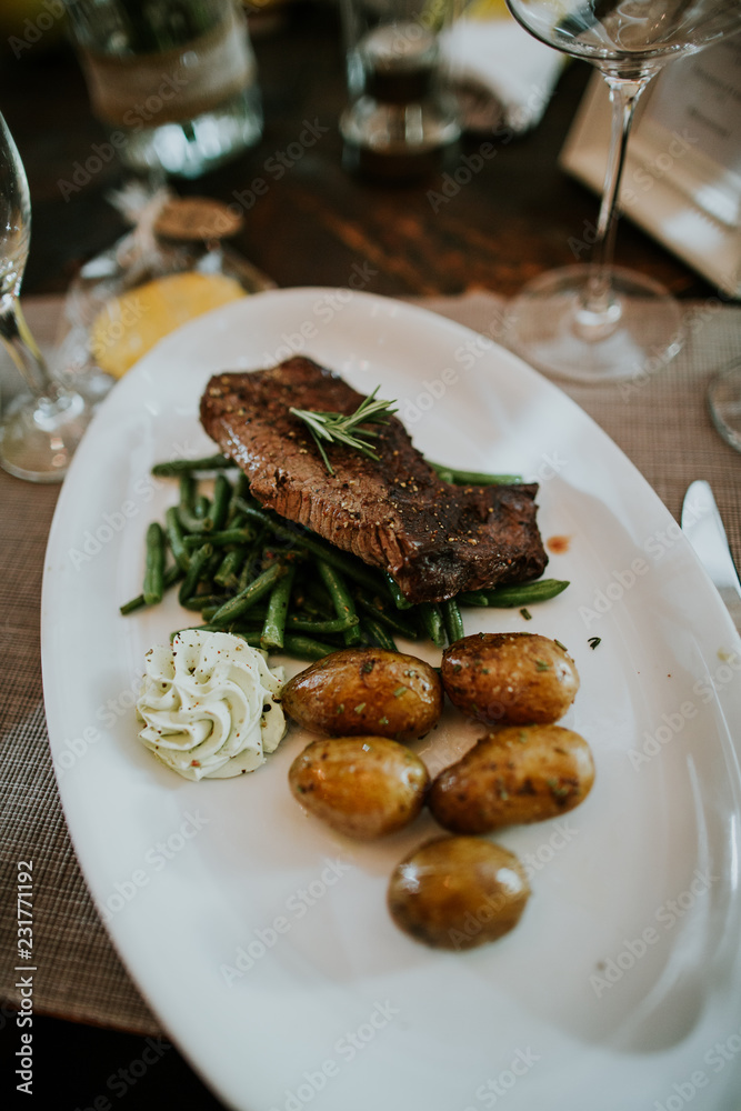 Grilled steak served with potatoes Grilled steak served with potatoes