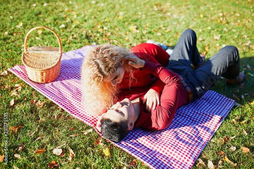 Romantic couple having picnic on the grass photo