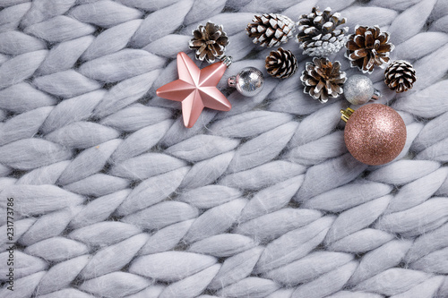 Fotografija Christmas wooden decor on gray background with cones, toys, balls and woolen pla
