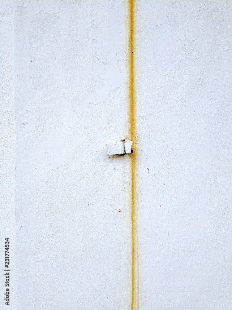 Rusty streak down a whitewashed wall Rusty streak down a whitewashed wall
