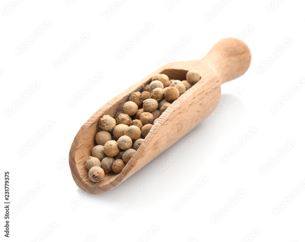Wooden scoop with pepper grains on white background Wooden scoop with pepper grains on white background