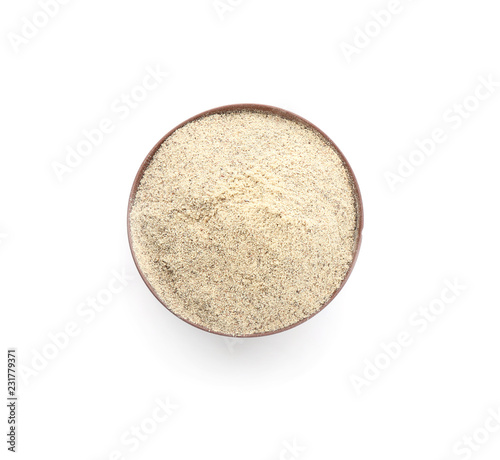 Bowl with pepper powder on white background, top view