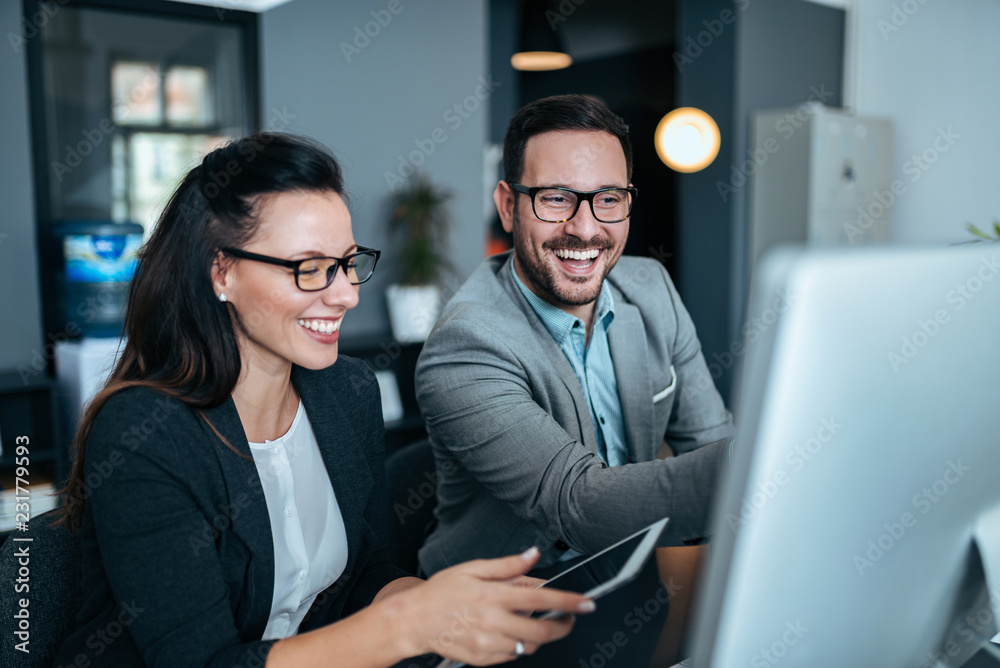 Fototapeta premium Two successful young business people working together.