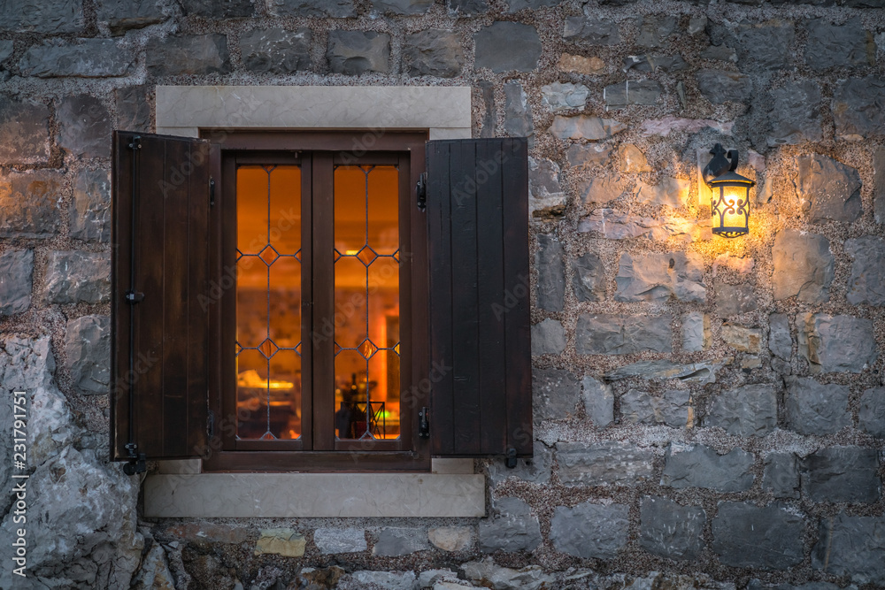 Window and shutters of a local cafe at night