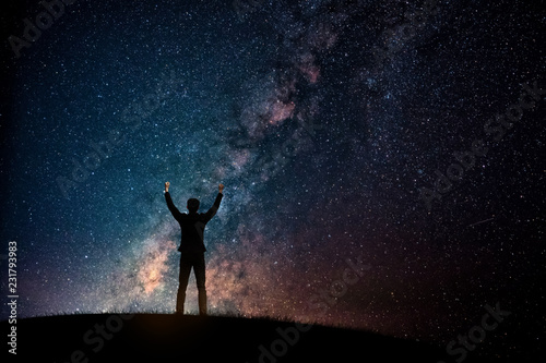Silhouette of businessman on starry night sky. Freedom or victory concept of Happy New year 2019. 