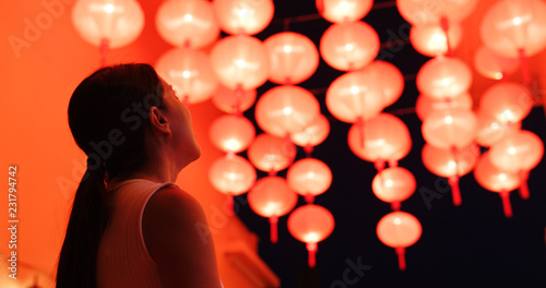 Woman look at the red lantern for mid autumn festival