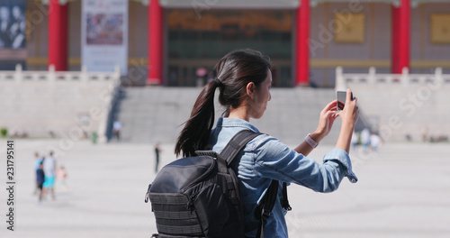 Travel woman take photo on cellphone in Chiang Kai shek Memorial Hall