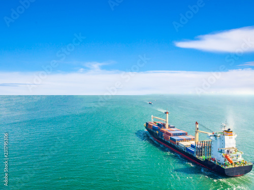 Aerial view of cargo ships that run in the middle of the sea are transported container to the port. Import export and shipping business logistic and transportation of International by ship