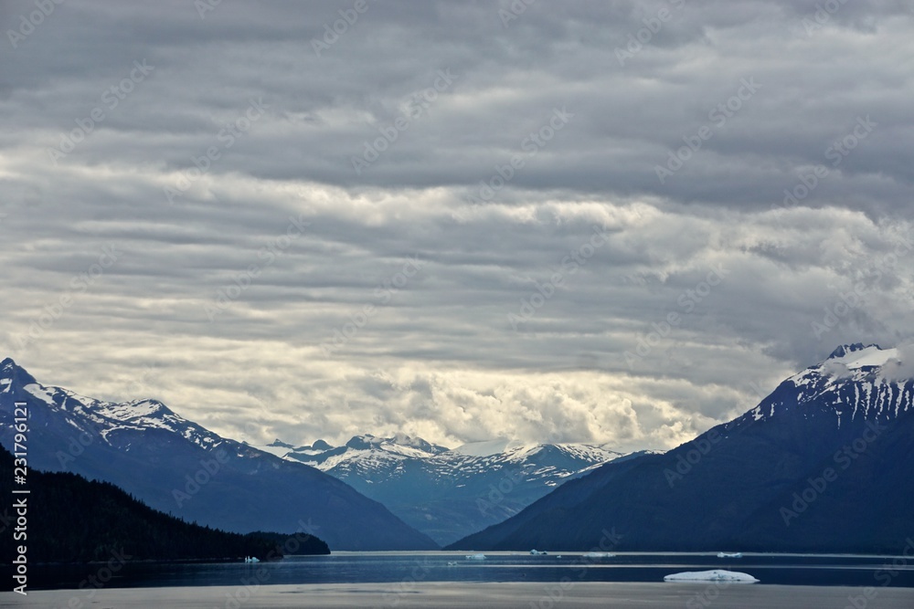 Endicott Arm, Alaska, USA: Distant view of a valley under a cloudy sky in the Endicott Arm, a fjord in the Pacific Northwest.