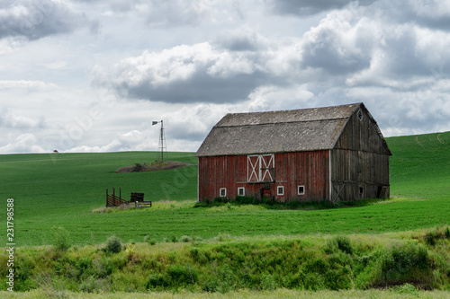 old red barn in field