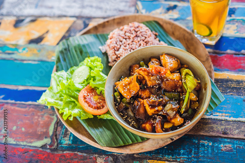 Popular Balinese meal of rice with variety of side dishes which are served together with the rice and more as optional extras photo