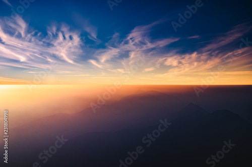 Out of focus of : Beautiful landscape with mist, sky and cloud from top mountain in Sunrise at Thailand.