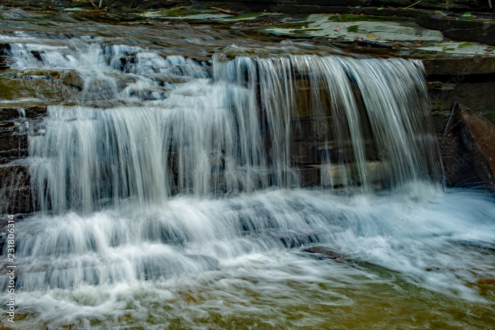 Waterfall cascading over the rocks near Finger lake trail