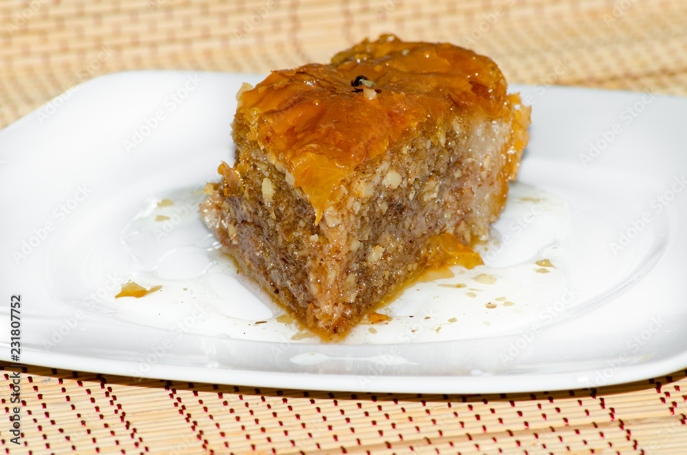 Baklava a rich, sweet dessert pastry layers of filo filled with chopped nuts and sweetened and held together with syrup or honey Baklava a rich, sweet dessert pastry layers of filo filled with chopped nuts and sweetened and held together with syrup or honey