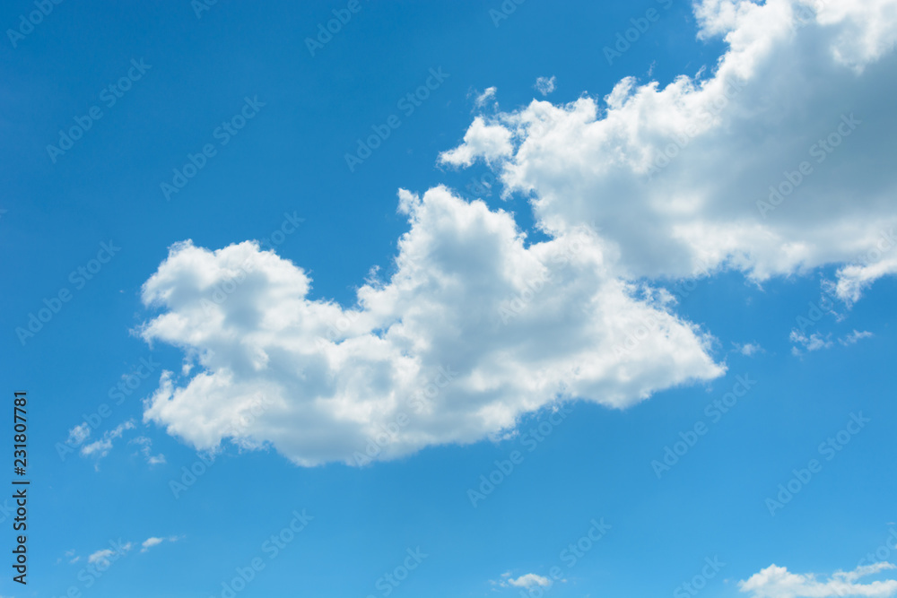 Obraz premium Two white clouds on the blue sky background