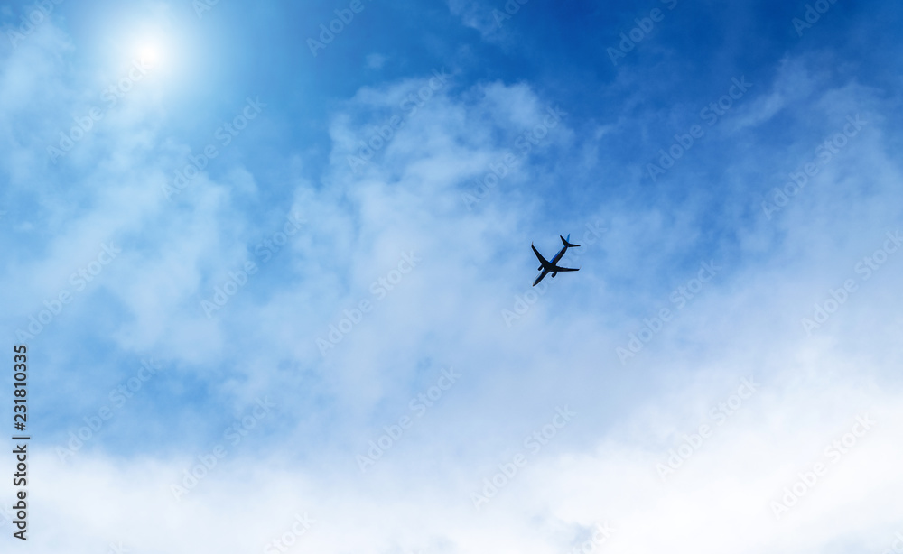 Airplane in the sky on a background of blue sky and white clouds. Airplane in the sky on a background of blue sky and white clouds.