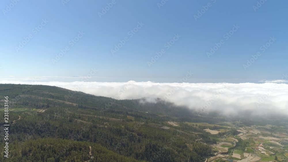 Aerial view of small town in Tenerife, flight over the clouds at sunny day. Spain, Canary Islands Aerial view of small town in Tenerife, flight over the clouds at sunny day. Spain, Canary Islands