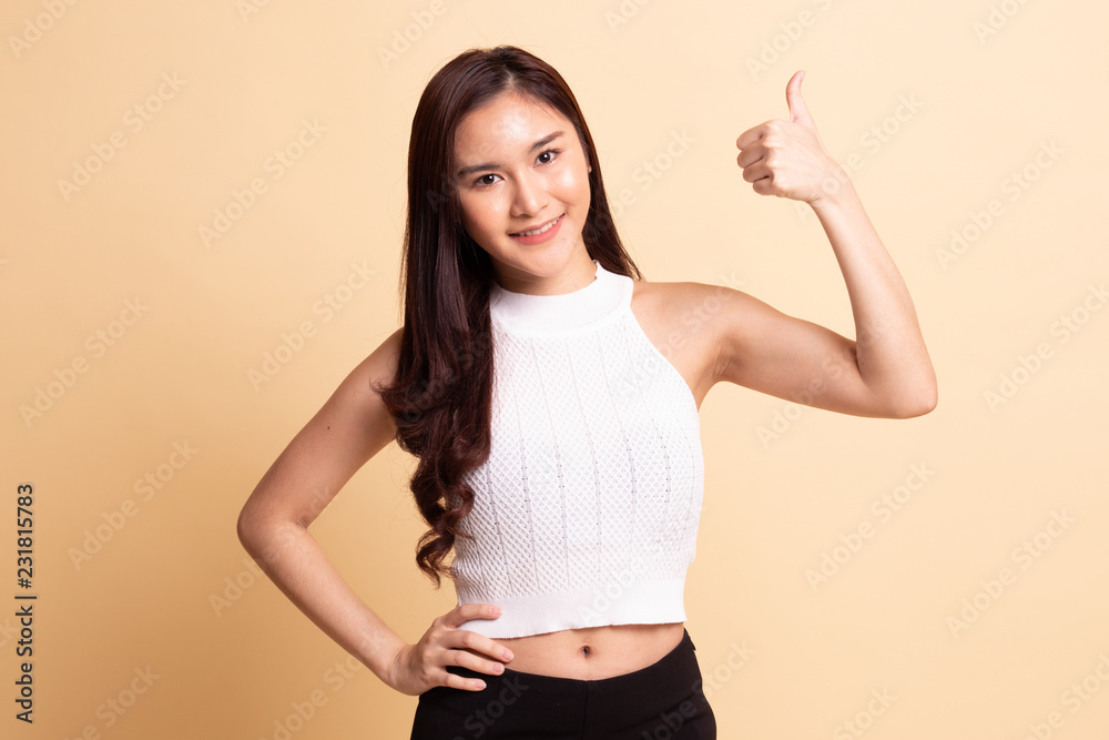 Young Asian woman show thumbs up. Young Asian woman show thumbs up.