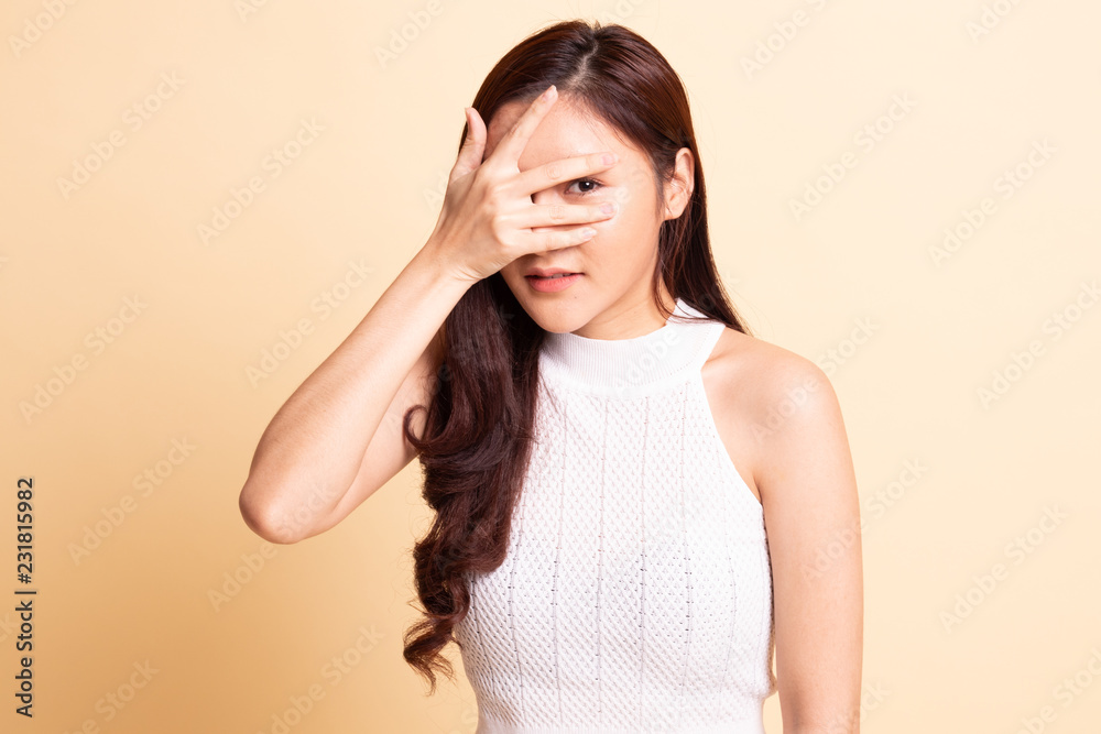 Beautiful young Asian woman peeking through fingers. Beautiful young Asian woman peeking through fingers.