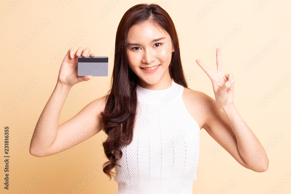 Young Asian woman show Victory with a blank card. Young Asian woman show Victory with a blank card.