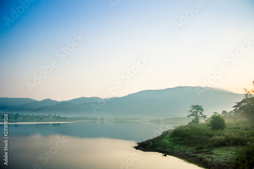 Mountain river with fog and forest on background