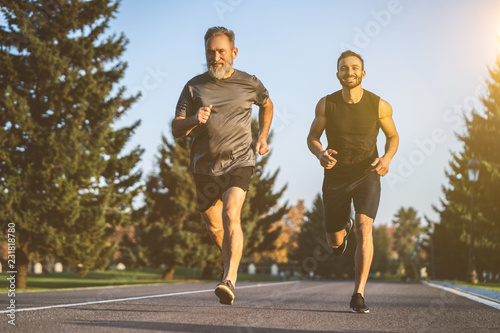 The father and a son running on a park road