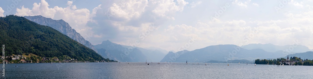 Panoramic view of mountains behind Schloss Ort, medieval castle on Traunsee lake, Salzkammergut, Austria