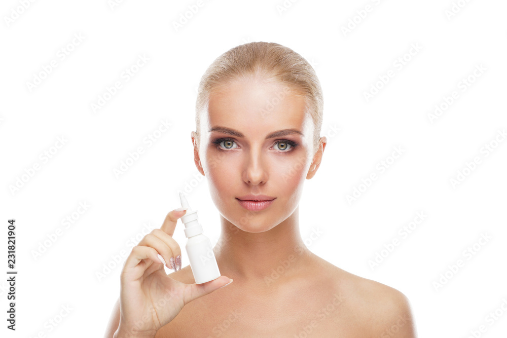Young girl using nosal spray aerosol and drops isolated on white. Runny nose, allergy, cold and flu illness, sinusitis and healthcare medicine concept.