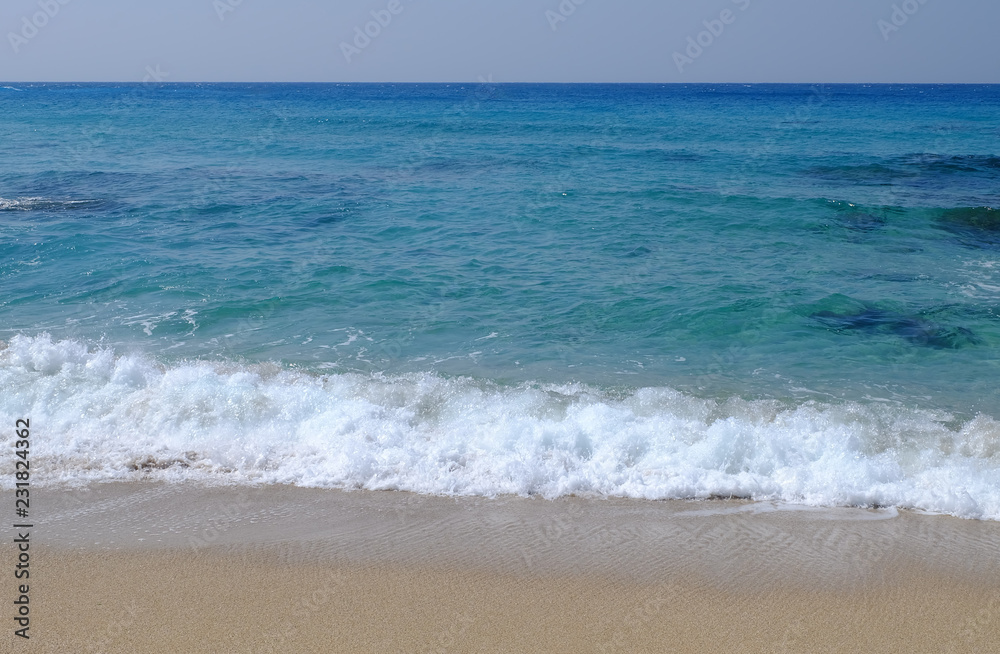 Tranquil image of Ocean in emerald and blue with waves and sand. Tranquil image of Ocean in emerald and blue with waves and sand.