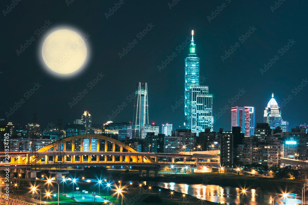 Night scenery of Taipei City with view of skyscrapers in downtown area, arch Bridges over Keelung River, Taiwan