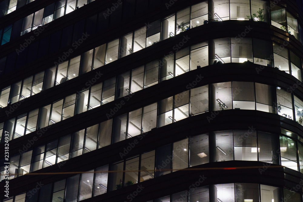 Lighted windows of business center at night. Work must be done on time! Lighted windows of business center at night. Work must be done on time!