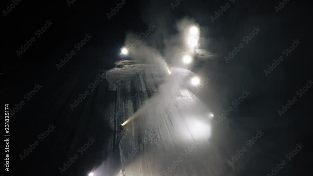 Aerial shot: The snow cannon's makes artificial snow at night. Winter sports Aerial shot: The snow cannon's makes artificial snow at night. Winter sports