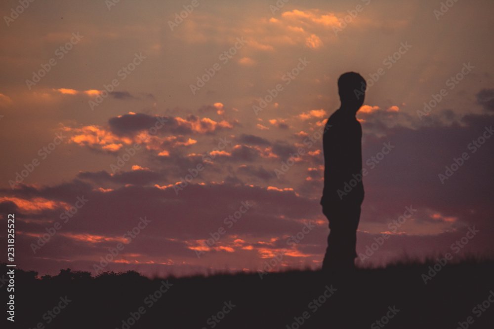 Silhouette of boy looking at sunset Silhouette of boy looking at sunset