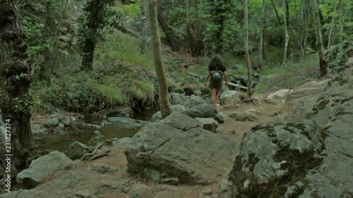 Girl hiking in the woods in nature photo